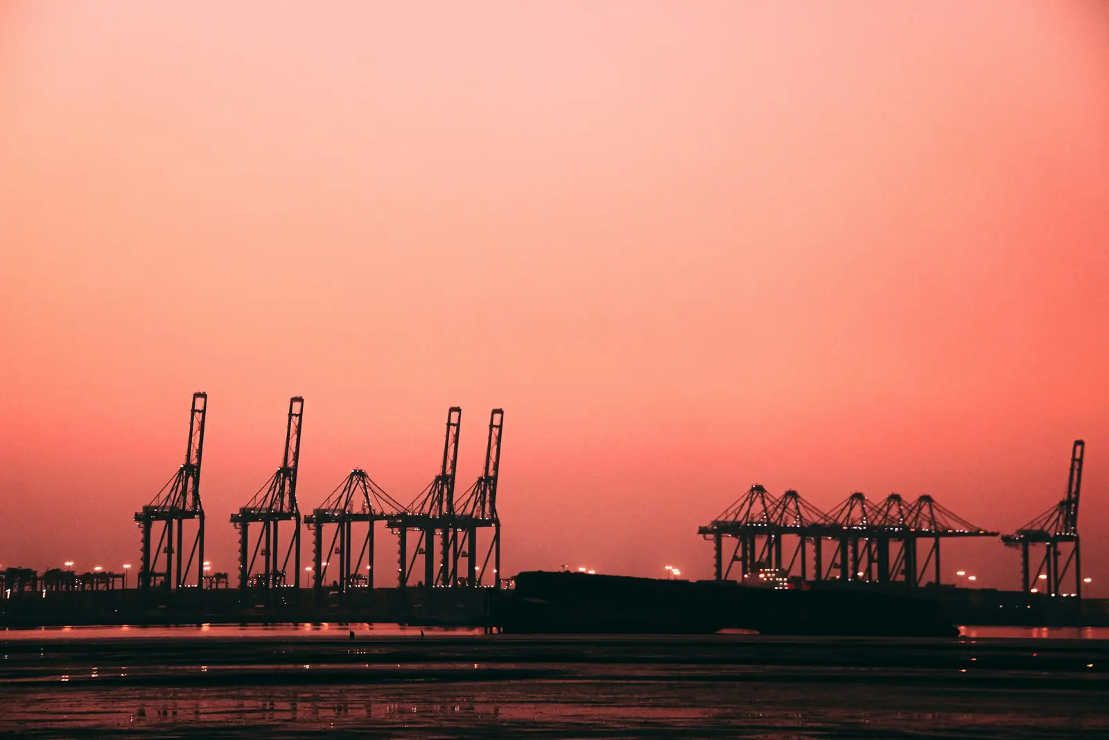 Ship-to-shore cranes at a Karachi container terminal at sunset