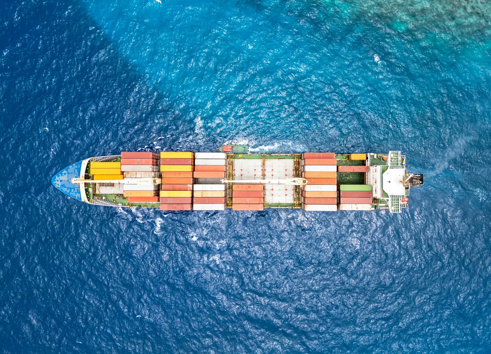 Aerial view of a loaded container ship at sea