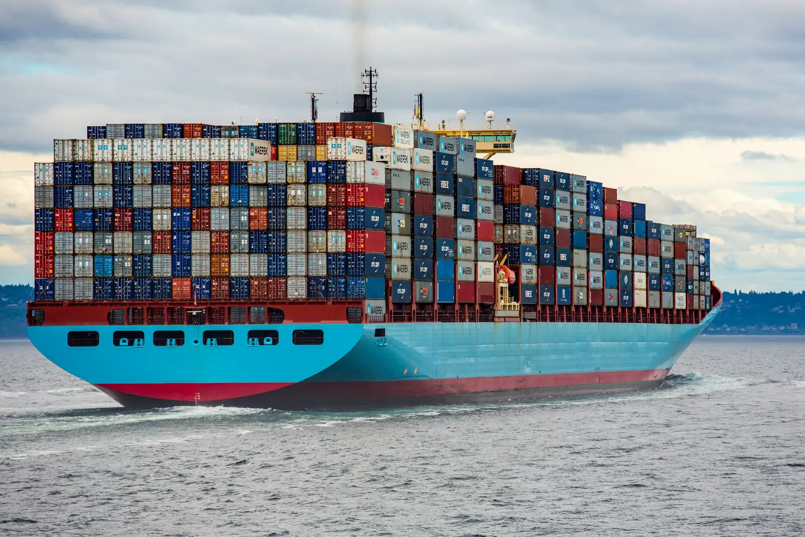 Container ship sailing along the coast
