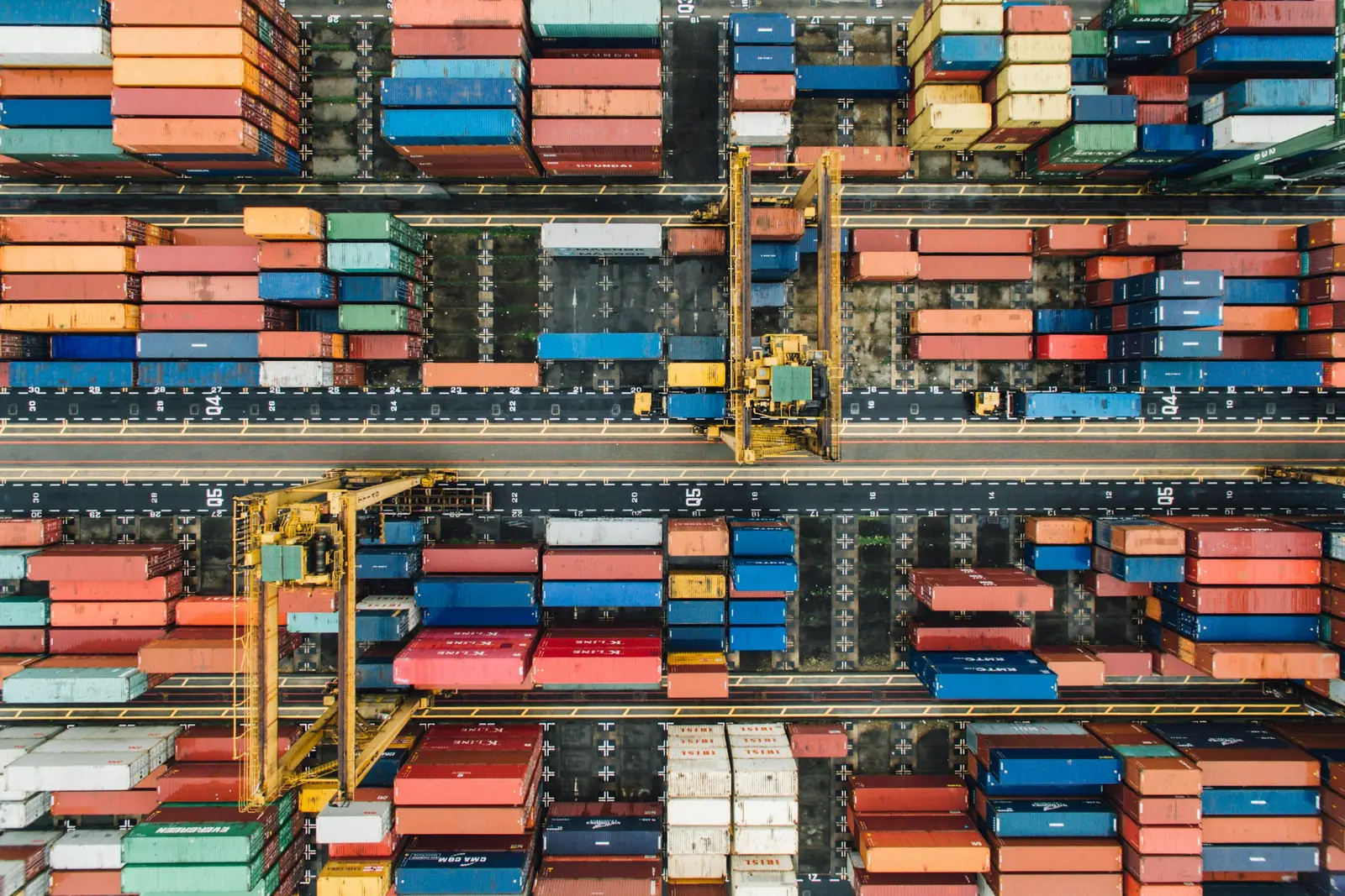 Aerial view of container yard lanes and cranes